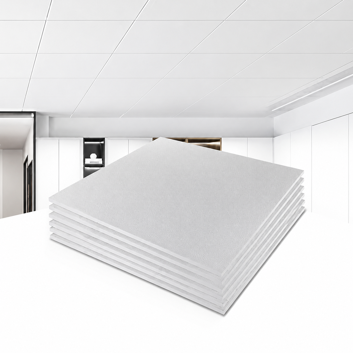 Stack of white ceiling panels in a room with white ceiling and walls