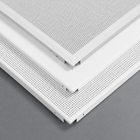 Close-up of white ceiling panels with perforated design on a gray background