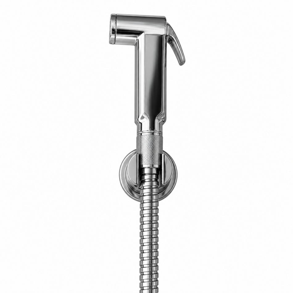 A polished chrome bidet shower sprayer with a flexible metal hose mounted on a beige tiled wall.