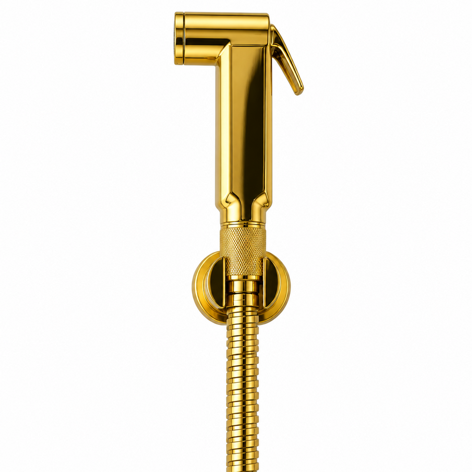 A polished gold handheld bidet shower sprayer with a matching hose and wall mount, shown against a clean white tiled background.