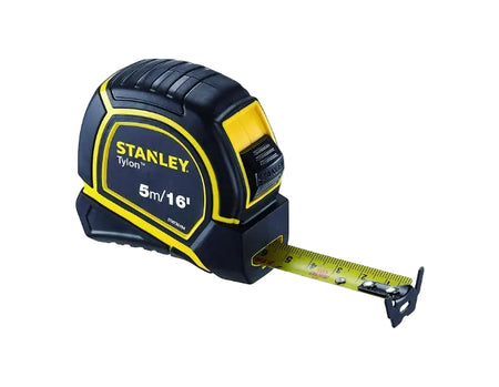 Stanley tape measure with extended tape on a white background