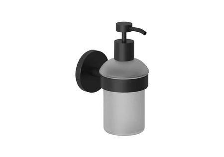 A wall-mounted frosted glass soap dispenser with matte black hardware, including a round wall plate, collar, and pump handle.